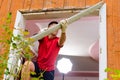 Worker removing old window in flat. Replacement of window frames Royalty Free Stock Photo