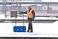 Worker removing snow from the station platform