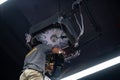 Worker repairing a ceiling air conditioning unit