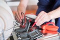 Worker repairing the dishwasher in the kitchen Royalty Free Stock Photo