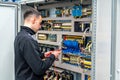 Worker repairing an electrical mechanical system in a factory