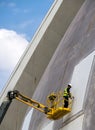 Worker Repairing Modern Building