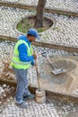 Worker repairing the sidewalk pavement with the traditional and typical handmade Royalty Free Stock Photo