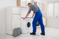 Worker Repairing Washer Royalty Free Stock Photo