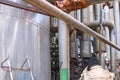 Worker repairman fitter welders in a mask repairing a pipeline, brewing a pipe, repairing equipment at an oil refining Royalty Free Stock Photo