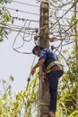 Worker repairs power line in Sri Lanka