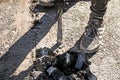 A worker repairs the road surface with a jackhammer on a summer day Royalty Free Stock Photo