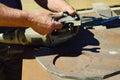 a worker replaces a grinding disc on a grinding machine that is wasted during metal cutting