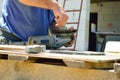 a worker replaces a grinding disc on a grinding machine that is wasted during metal cutting