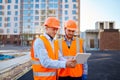 Worker reporting to contractor at construction site Royalty Free Stock Photo