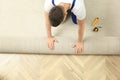 Worker rolling out new carpet flooring indoors, top view Royalty Free Stock Photo