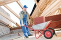 Worker roofer and wheel barrow Royalty Free Stock Photo