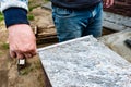 Worker`s hand measuring tile to be cut. Royalty Free Stock Photo
