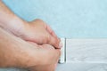 Worker`s hands Instal plastic skirting board on laminate flooring. Renovation of baseboard at home Royalty Free Stock Photo