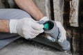 Worker`s hands are installing sewer pipes.