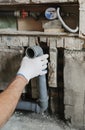 Worker`s hands are installing sewer pipes.