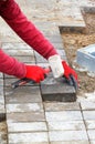 A worker`s hands are laying paving slabs on the pavement Royalty Free Stock Photo