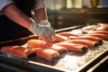 Worker\'s hands process salmon steak on ice. Chilled fish at a fish processing plant. Ice and salmon. Salmon fillets