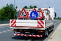 A worker`s truck with roadsigns at a road construction site