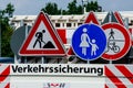 A worker`s truck with roadsigns at a road construction site