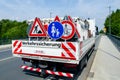 A worker`s truck with roadsigns at a road construction site