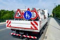 A worker`s truck with roadsigns at a road construction site