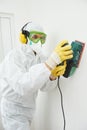 Worker with sander at wall filling Royalty Free Stock Photo