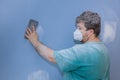 Worker sanding the drywall mud using sand trowel during renovation the house Royalty Free Stock Photo