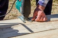 worker`s hands sawing boards with a jigsaw at a construction site Royalty Free Stock Photo