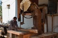 Sur, Oman - November 27 2019 Worker sawing ship planks in traditional dhow wharf in Sur, Oman