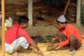 Worker Sawing Wood At Construction Site