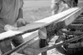 Worker at a sawmill guiding a plank