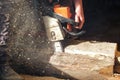 The worker saws off a log with a chainsaw Royalty Free Stock Photo