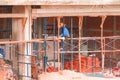 Worker on scaffold in construction site Royalty Free Stock Photo