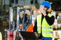 Worker with scanner and laptop at forwarding Royalty Free Stock Photo