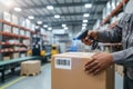 Worker scanning barcode on a box in a warehouse Royalty Free Stock Photo