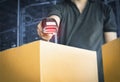 Worker scanning barcode scanner with red laser on parcel box. Shipment, Computer equipment for warehouse inventory management Royalty Free Stock Photo