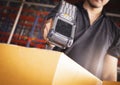 Worker scanning barcode scanner with red laser on parcel box. Shipment, Computer equipment for warehouse inventory management Royalty Free Stock Photo