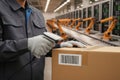 Worker scanning package with barcode reader in automated warehouse Royalty Free Stock Photo