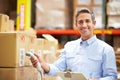 Worker Scanning Package In Warehouse