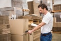 Worker scanning package in warehouse Royalty Free Stock Photo