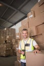 Worker scanning package in warehouse Royalty Free Stock Photo