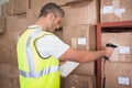 Worker scanning package in warehouse Royalty Free Stock Photo