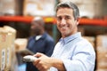 Worker Scanning Package In Warehouse