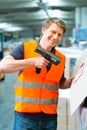 Worker scans package in warehouse of forwarding Royalty Free Stock Photo