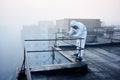 Worker scientist wearing protective coverall and gas mask doing ecological tests on the roof