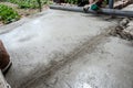 Worker screeding outdoor cement floor with screed Royalty Free Stock Photo