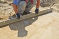 Worker screeding sand bed Royalty Free Stock Photo