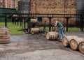 Worker Sealing Barrels as they Roll