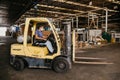 Worker seated at the rear of a warehouse forklift at Panan wooden craft factory